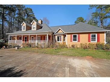 Charming single-story home featuring a welcoming front porch and vibrant red shutters at 210 Cowan Se Rd, Conyers, GA 30094
