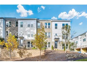 Stylish townhome exterior showcasing a modern design with a landscaped front yard and inviting entrance at 2539 Astaire Ct, Atlanta, GA 30318