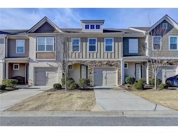 Charming townhomes showcase varied facades, complemented by well-kept landscaping and private driveways at 5264 Mill Way, Stone Mountain, GA 30083