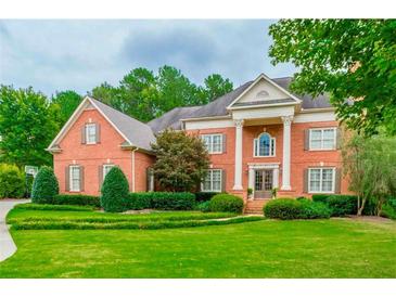 Charming two-story brick home with a meticulously manicured front lawn, enhanced by mature trees at 6205 Arnall Nw Ct, Acworth, GA 30101