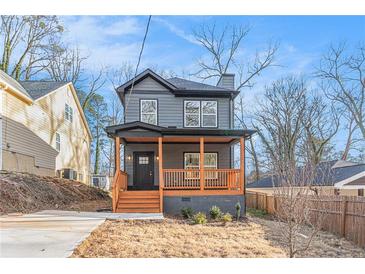 Charming two-story home features a welcoming front porch and a modern gray exterior at 2058 Detroit Nw Ave, Atlanta, GA 30314