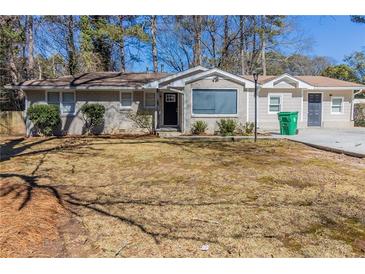 Charming single-story home with a brick facade, well-maintained landscaping, and a welcoming entrance at 3716 Loren Dr, Decatur, GA 30032