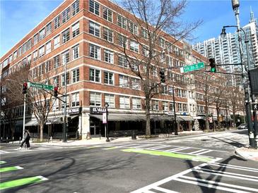 Street view of brick building with shops and restaurants, featuring sidewalks and crosswalks at 800 Peachtree Ne St # 8415, Atlanta, GA 30308