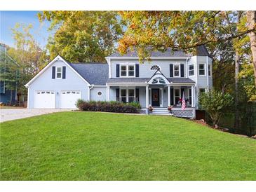 Charming two-story home with a well-manicured lawn, two-car garage, and welcoming front porch at 1421 Eryn Cir, Suwanee, GA 30024
