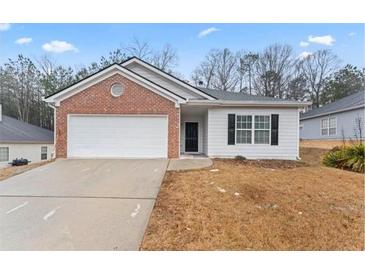 Charming single-story home with a brick and white siding, complemented by an attached two-car garage at 10231 Deep Creek Pl, Union City, GA 30291