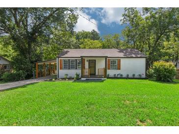Charming single-story home with fresh green lawn and carport at 169 Wadley Nw St, Atlanta, GA 30314