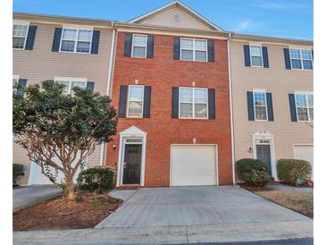 Charming townhome with a well-manicured lawn and a one car garage, perfect for modern living at 5362 Hickory Nw Knl, Norcross, GA 30071