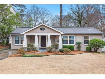 Charming single-story home featuring a welcoming front porch and well-maintained landscaping at 2413 Drew Valley Rd, Brookhaven, GA 30319