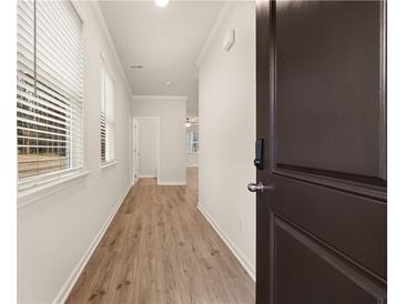 Inviting entryway featuring wood-look floors and ample natural light from the windows at 1084 Georgian Point Dr, Lawrenceville, GA 30045