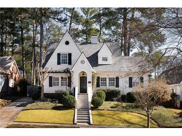 Charming two-story white home with a beautifully landscaped front yard and inviting entryway at 1843 Flagler Ne Ave, Atlanta, GA 30309