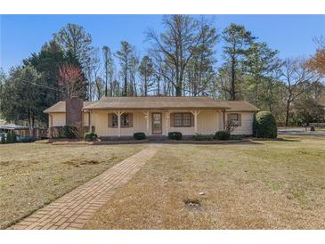 Charming single-story home with brick pathway and well-maintained landscaping at 3439 Elm Creek Nw Dr, Marietta, GA 30064