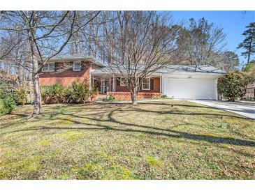 Charming brick home with a manicured lawn and a two-car garage, perfect for suburban living at 2447 Caladium Ne Dr, Atlanta, GA 30345