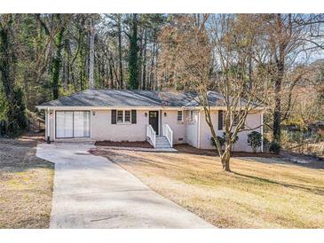 Charming brick home featuring a well-manicured lawn and a welcoming entrance at 2239 Pinewood Dr, Decatur, GA 30032