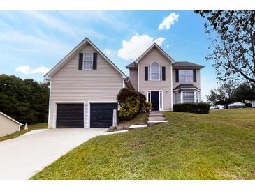 Charming two-story home boasts a well-manicured lawn and a two-car garage for ample parking at 3068 River Oak Rd, Decatur, GA 30034