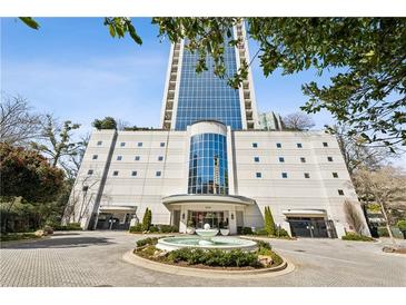 Low angle shot of the building with a circular driveway and tiered water fountain at 2828 Peachtree Nw Rd # 1701, Atlanta, GA 30305