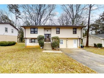 Inviting two-story home featuring neutral siding, brick accents, landscaped front yard, and a double driveway at 2284 Emerald Springs Dr, Decatur, GA 30035