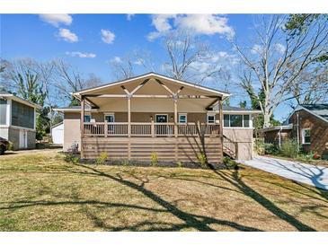 Charming brick home with a welcoming front porch and well-maintained lawn at 1826 Terry Mill Se Rd, Atlanta, GA 30316