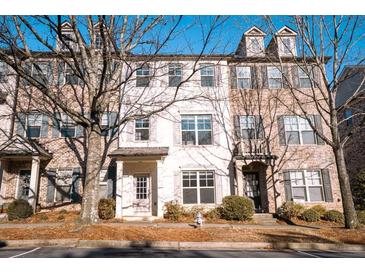 Charming townhouse exterior with brick and painted facade, enhanced by mature landscaping and abundant natural light at 1480 Baygreen Rd, Suwanee, GA 30024