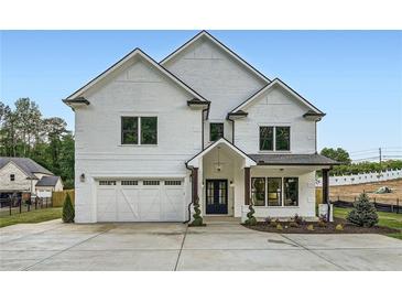 Stunning white brick home with a well-manicured lawn, a two-car garage, and a welcoming entryway at 1523 Grayson Pkwy, Grayson, GA 30017