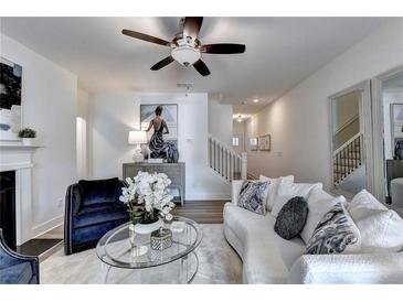 Bright living room featuring modern decor, fireplace, and hardwood floors at 172 Ne Almand Ln, Conyers, GA 30013