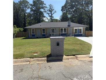 Charming single-story home with a well-manicured front lawn and classic brick mailbox at 471 Tipton Dr, Riverdale, GA 30274