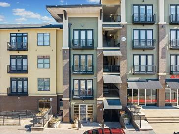 View of a modern apartment building with balconies and brick accents under a bright sky at 5300 Peachtree Rd # 3507, Chamblee, GA 30341