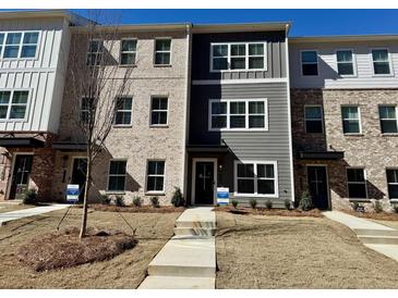New construction townhome with brick and siding details and small front yard at 5455 Blossomwood Sw Trl, Mableton, GA 30126