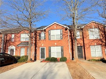 Brick townhome with a well-maintained front yard and a concrete driveway at 3011 Waldrop Cir, Decatur, GA 30034