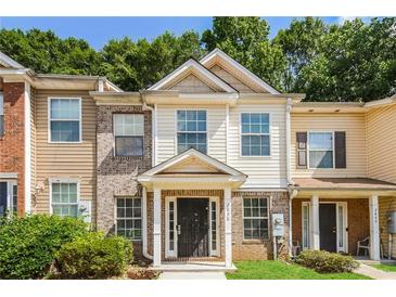 Inviting two-story townhome featuring mixed siding and manicured front lawn at 2838 Vining Ridge Ter # 0, Decatur, GA 30034