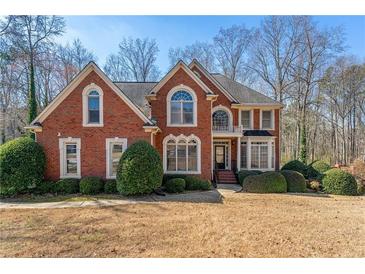 Charming brick home with a well-manicured front lawn and mature landscaping at 1290 Regency Center Sw Dr, Atlanta, GA 30331