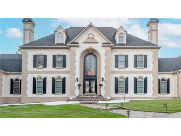 Elegant two-story home featuring a symmetrical design and a stone walkway leading to the grand arched entrance at 1806 Wynthrop Manor Sw Dr, Marietta, GA 30064