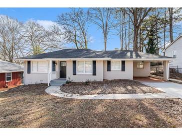 Charming single-story home featuring a covered carport and manicured front yard at 2867 Mitchell Dr, Decatur, GA 30032