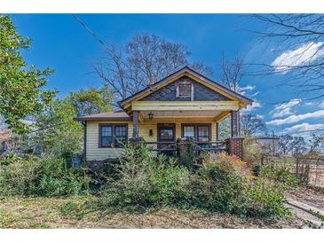 Charming bungalow featuring a cozy front porch and mature landscaping at 3630 Union Ave, Hapeville, GA 30354