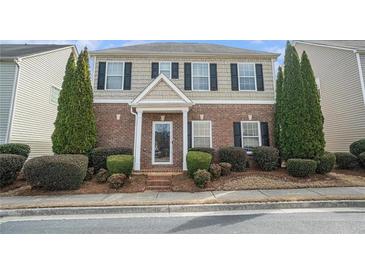 Charming two-story home with brick and siding, showcasing manicured landscaping and a welcoming entrance at 3272 Tiara Sw Cir, Atlanta, GA 30311