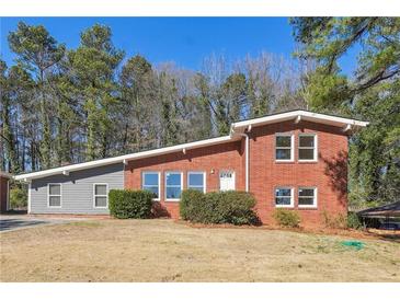 Charming brick home with a well-maintained lawn, perfect for families or those seeking a peaceful retreat at 3035 Mclendon Nw Cir, Atlanta, GA 30318