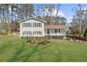 Charming two-story home with a well-manicured lawn and welcoming front porch at 322 Foxfire Sw Dr, Smyrna, GA 30082