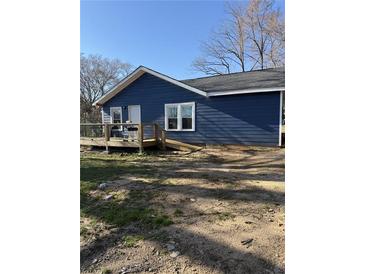Charming home featuring navy blue siding, a wooden deck, and well-maintained landscaping at 3814 Rex Rd, Rex, GA 30273
