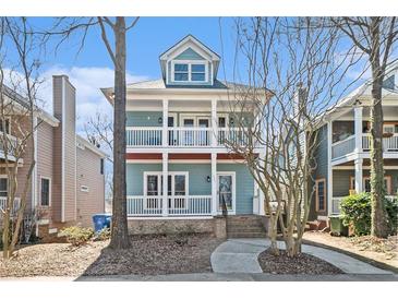 Charming two-story home featuring a double porch, light blue siding, and inviting curb appeal at 1032 Lena Nw St, Atlanta, GA 30314
