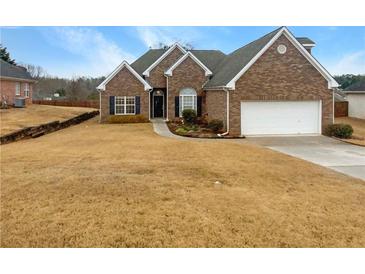 Charming brick home with well-maintained landscaping and a two-car garage at 123 Laurel Springs Dr, Mcdonough, GA 30253