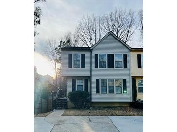 Charming home featuring black shutters, complemented by a well-kept lawn and driveway at 1069 Falling Water Se Dr, Smyrna, GA 30080