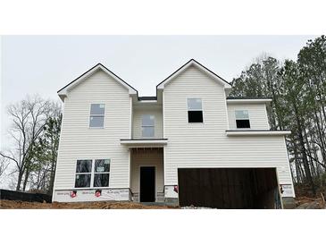 New two-story home featuring white siding, a two-car garage, and an inviting covered entryway at 120 Cedar Cliff Ct, Temple, GA 30179