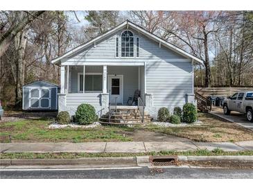 Charming home featuring updated light gray paint and a cozy front porch entrance at 4985 Union St, Union City, GA 30291