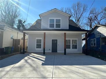 Charming home featuring a gray exterior, covered porch, and a wide driveway at 958 Joseph E Boone Nw Blvd, Atlanta, GA 30314