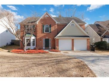 Charming two-story brick home featuring a well-manicured lawn and two-car garage at 4284 Hathaway Nw Ct, Kennesaw, GA 30144