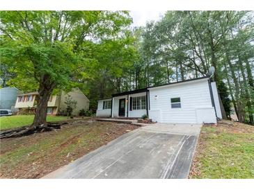 Charming single Gathering home featuring a well-maintained yard and a private driveway at 1995 Northerly Way, Stone Mountain, GA 30088