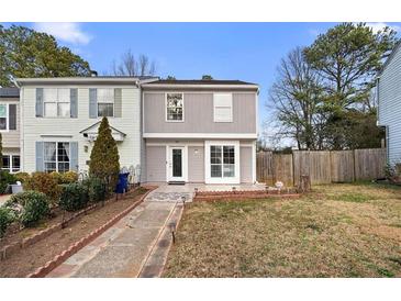 Charming townhouse with a well-manicured lawn and inviting walkway to the front door at 3177 Shadow Walk Ln, Tucker, GA 30084