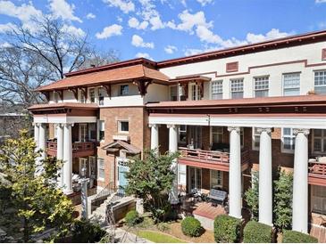 Stunning condo exterior with stately columns, balconies, and manicured landscaping at 746 N Highland Ne Ave # 11, Atlanta, GA 30306