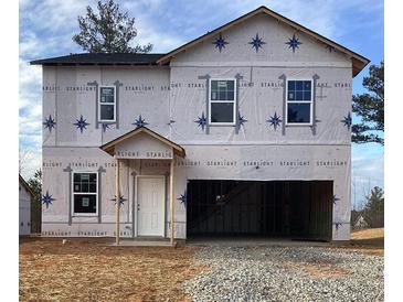 New construction home exterior view, showcasing the frame and windows against a blue sky at 147 Silverton Dr, Dacula, GA 30019