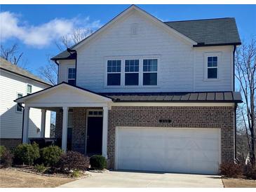 Charming two-story home with a brick facade, attached garage, and well-maintained landscaping at 5345 Coltman Dr, Cumming, GA 30028