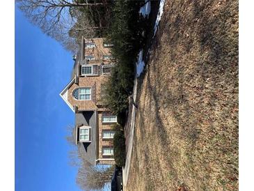 Charming brick two-story home with meticulously landscaped yard, and mature trees at 69 Ridgeway Dr, Villa Rica, GA 30180